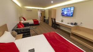 A hotel room with two beds, a desk, a TV, and a kitchenette. - V Motel (Christchurch)