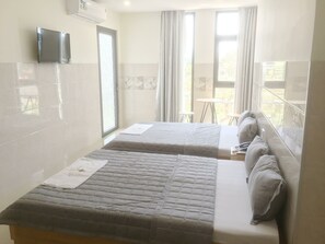 Triple Room | Minibar, desk, blackout drapes, iron/ironing board