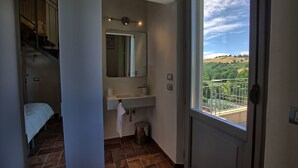 A bathroom with a sink, mirror, and a view of a balcony with a scenic landscape. - Beautiful private villa for 8 guests with WIFI, A/C, pool, TV, patio and panoramic view (Ostra)