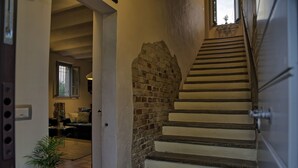 A staircase with a brick wall on one side and a white door on the other. - Beautiful private villa for 8 guests with WIFI, A/C, pool, TV, patio and panoramic view (Ostra)