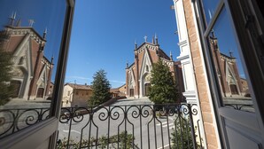 A view of a church with a prominent bell tower and a clear blue sky.