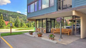 A hotel with a covered entrance, outdoor seating, and a view of a mountainous landscape. - Ski Condo With Short Walk to Lifts SH501 (Copper Mountain)