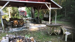 An outdoor patio with a fire pit, tables, chairs, and a barbecue grill. - Historical Little Switzerland - Room 5 (Jasper)