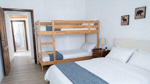 A bunk bed room with a wooden ladder, a nightstand with a lamp, and a door leading to another room. - Retreat in the old town, Base for the Matese (Bojano)