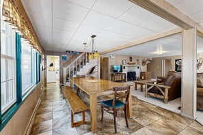 Relax in a spacious living area with a dining table, comfortable seating, and a TV for entertainment.