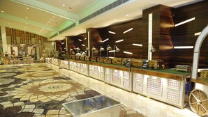 A spacious lobby with a patterned floor, a reception desk, and modern lighting fixtures. - Lotus Ananta Elite Kota (Kota)