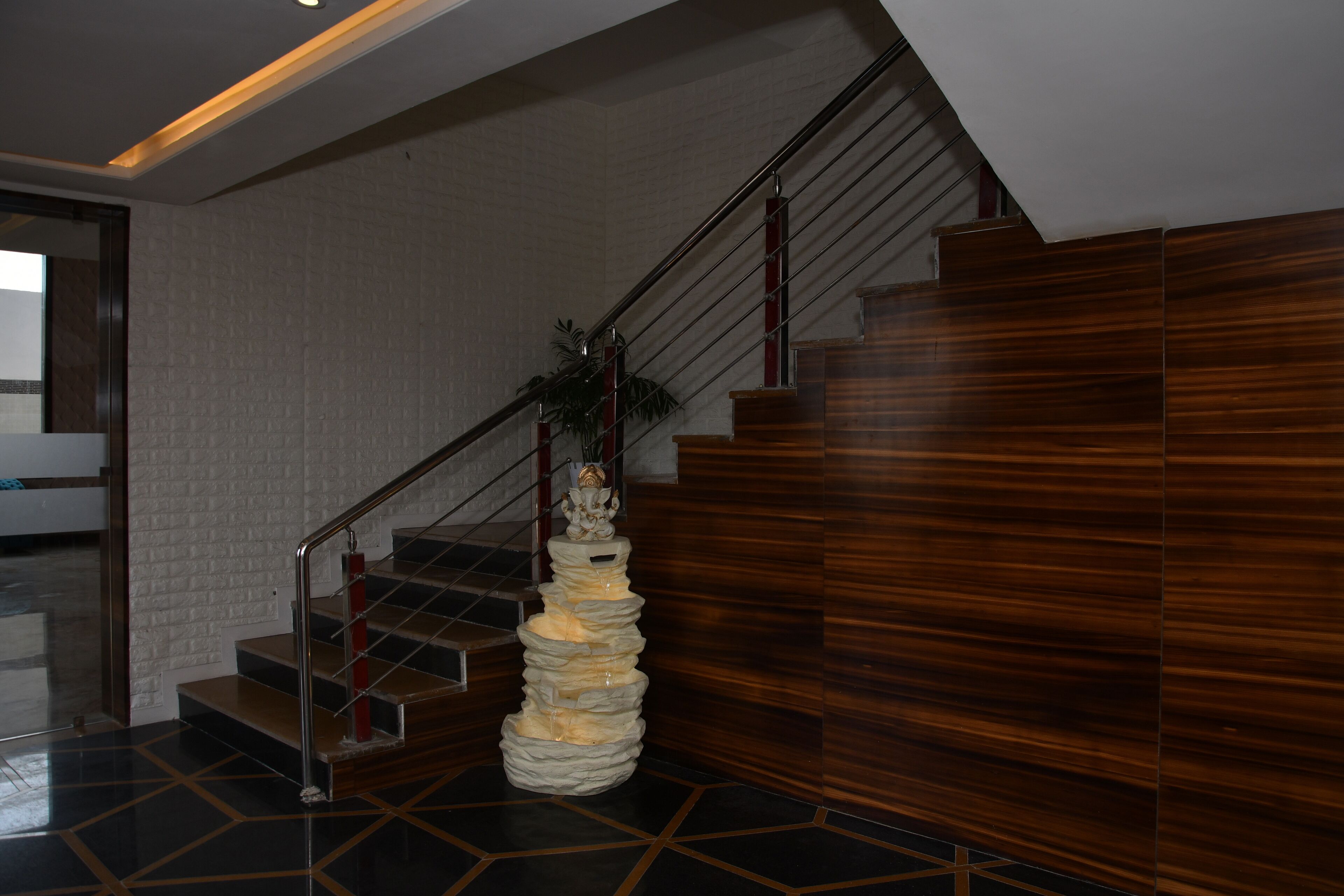 A staircase with a modern design, featuring a wooden finish and a metal handrail.