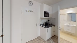 Uma cozinha moderna com micro-ondas, torradeira e pia.