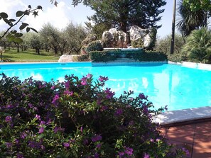Seasonal outdoor pool, open 9:30 AM to 7:00 PM, pool loungers