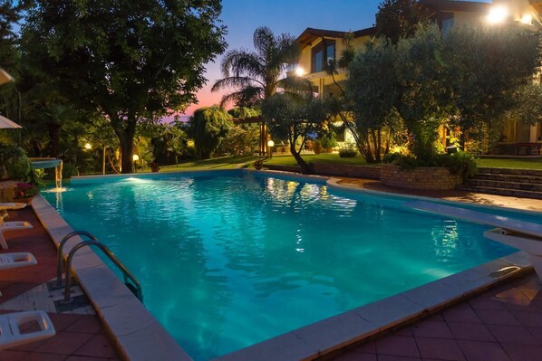 Seasonal outdoor pool, open 9:30 AM to 7:00 PM, pool loungers
