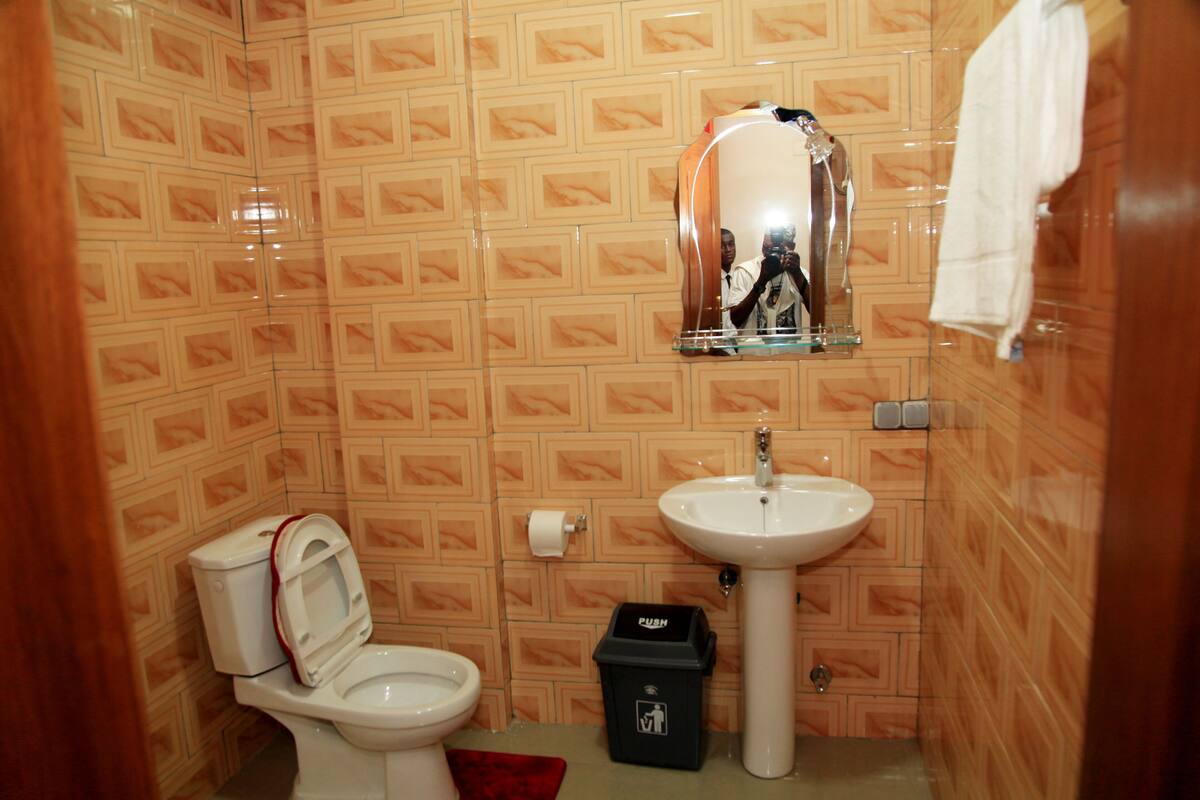deluxe room | bathroom | shower, rainfall showerhead, free toiletries, bathrobes