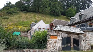 A stone building with a sign reading "Le Marquis." - Gite le Marquès in Aubrac with spa (Saint-Chély-d'Aubrac)