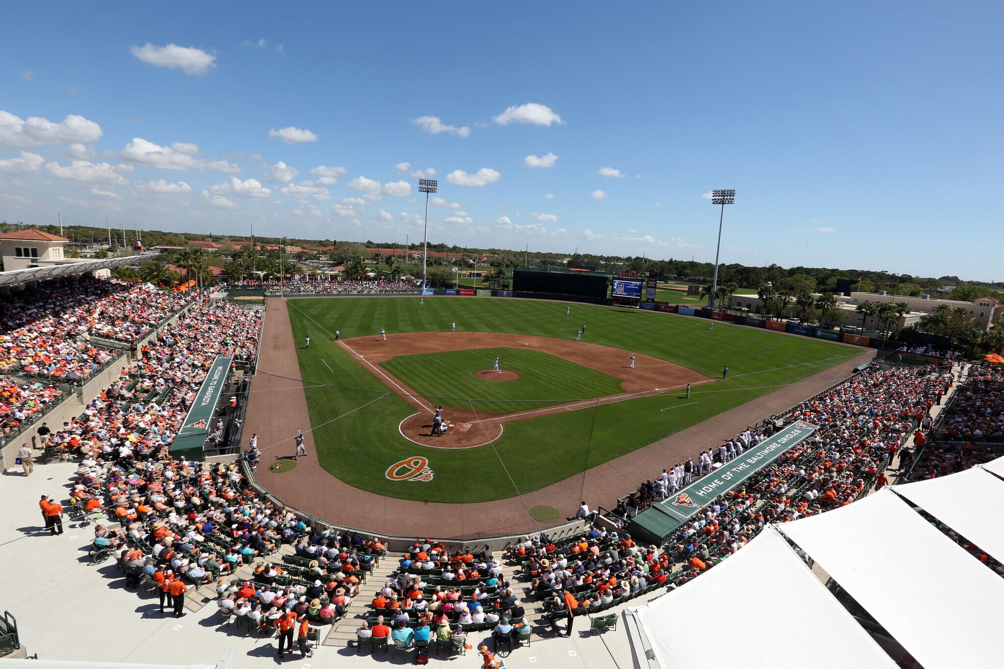 A baseball stadium with a large seating area, a baseball diamond, and a scoreboard.