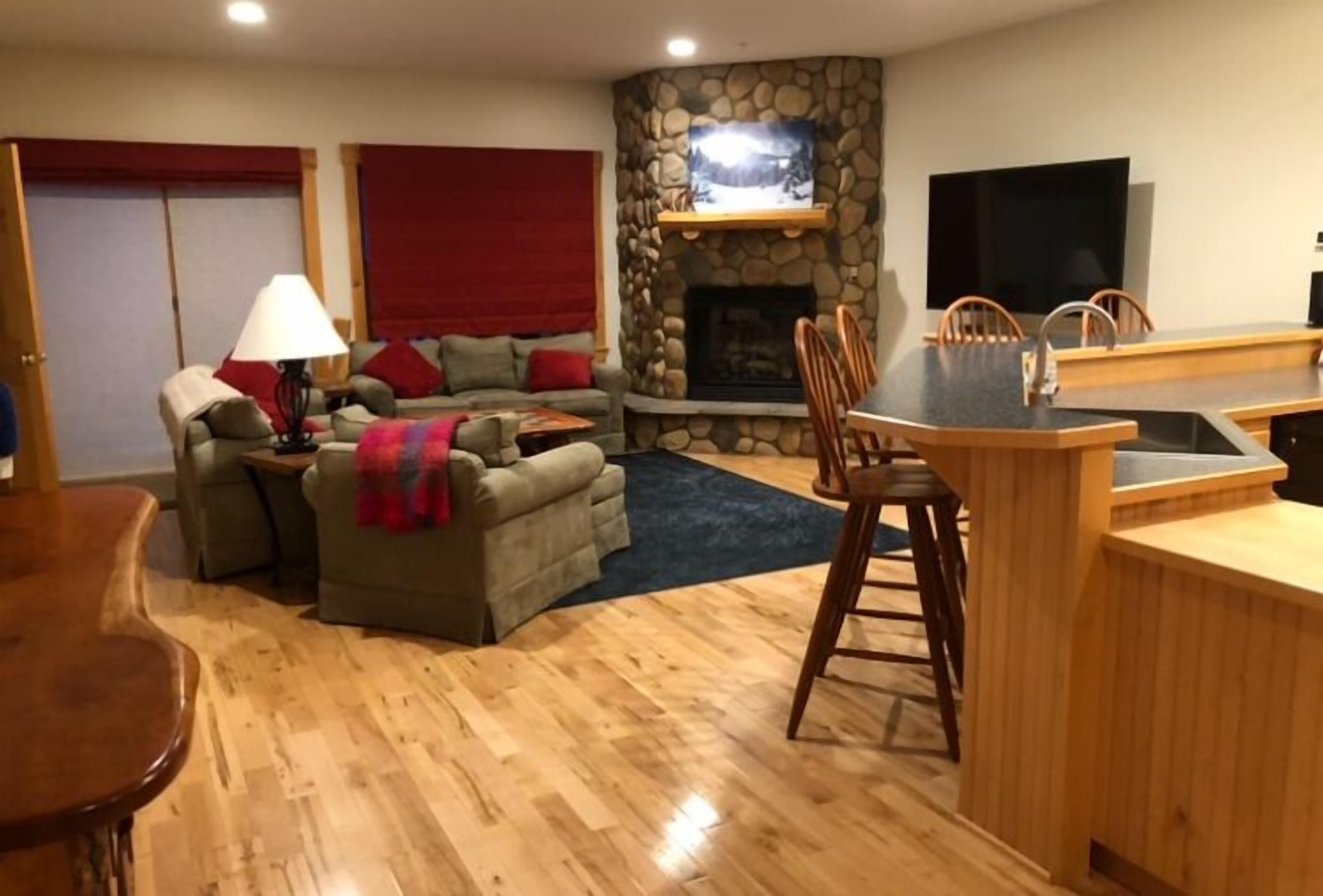 Living room with sliding door to deck for direct trail access, on second floor.