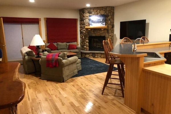 Living room with sliding door to deck for direct trail access, on second floor.