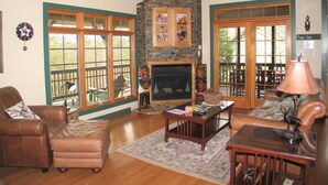 A living room with a fireplace, leather furniture, and large windows. - 5 Free Daily Bryce Resort Passes!  Skiing, Tubing, Golf, Mountain Biking, Lake!  (Basye)