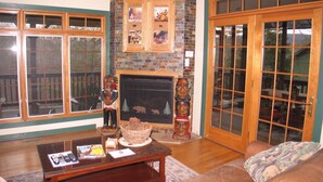 A living room with a fireplace, large windows, and a sliding glass door. - 5 Free Daily Bryce Resort Passes!  Skiing, Tubing, Golf, Mountain Biking, Lake!  (Basye)