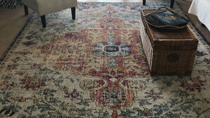 A living room with two armchairs, a patterned rug, and a wicker chest of drawers. - Chateaux #406  Charming Beachfront Retreat with spectacular views! (Indian Shores)