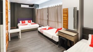 A hotel room with two beds, a desk, a chair, a mirror, and a window with curtains. - OYO 89381 Moonnight Hotel (Batu Caves)