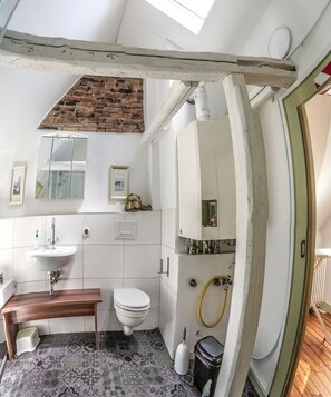 Shower, hair dryer, slippers, towels
