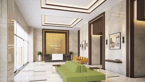 A modern lobby with a reception desk, a green sofa, and a large framed picture on the wall. - Ami Splendid Rivergate Views (Ho Chi Minh City)