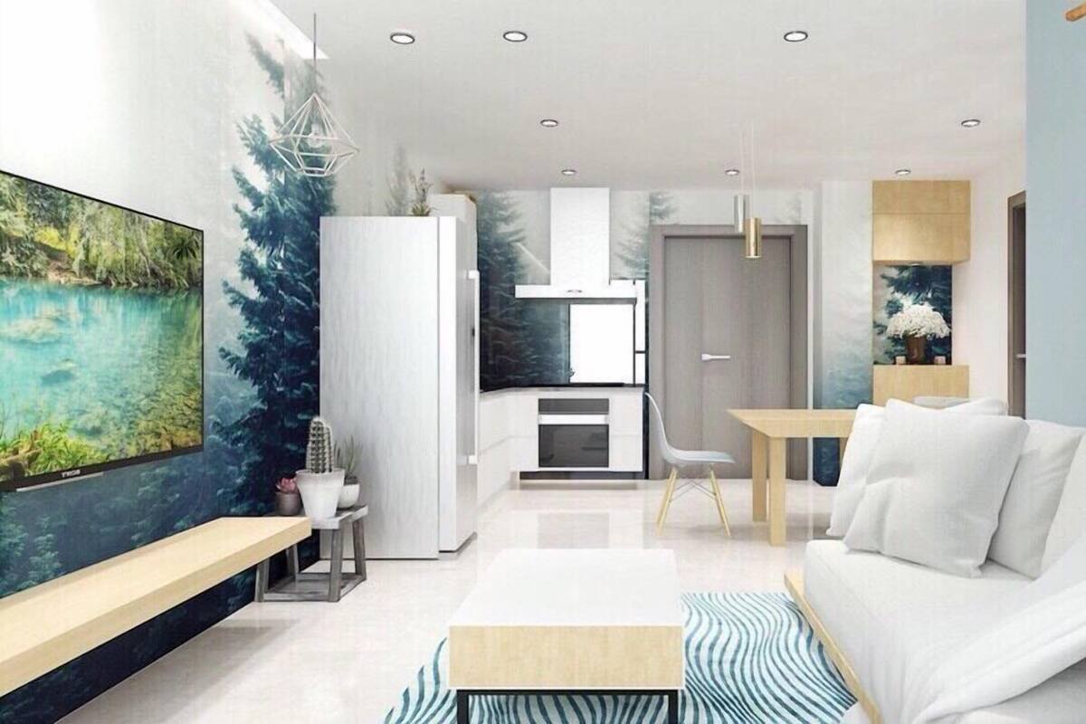 A modern living room with a white sofa, a coffee table, and a dining area with a wooden table and chairs.
