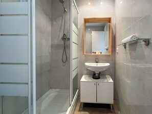 Shower, rainfall showerhead, hair dryer, towels
