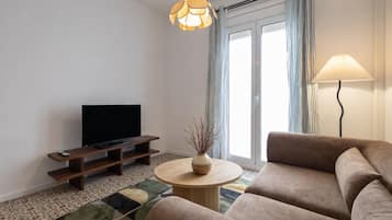 Apartment | Living area | 65-inch TV with cable channels