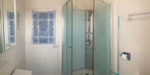 Shower, hair dryer, soap, toilet paper