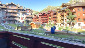 A mountain resort with multi-story buildings featuring balconies and wooden exteriors.