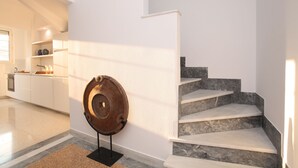 A modern kitchen with white cabinets, a granite countertop, and a stainless steel sink. - Plaka 2-storey Penthouse with Acropolis views. PL6 (Athens)