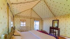 A tent-style room with a bed, a chair, and a mirror. - Jaisalmer Khodiyar Resort - Campsite (Jaisalmer)