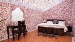 A bedroom with a wooden bed, a desk, a chair, and a window. - Jaisalmer Khodiyar Resort - Campsite (Jaisalmer)