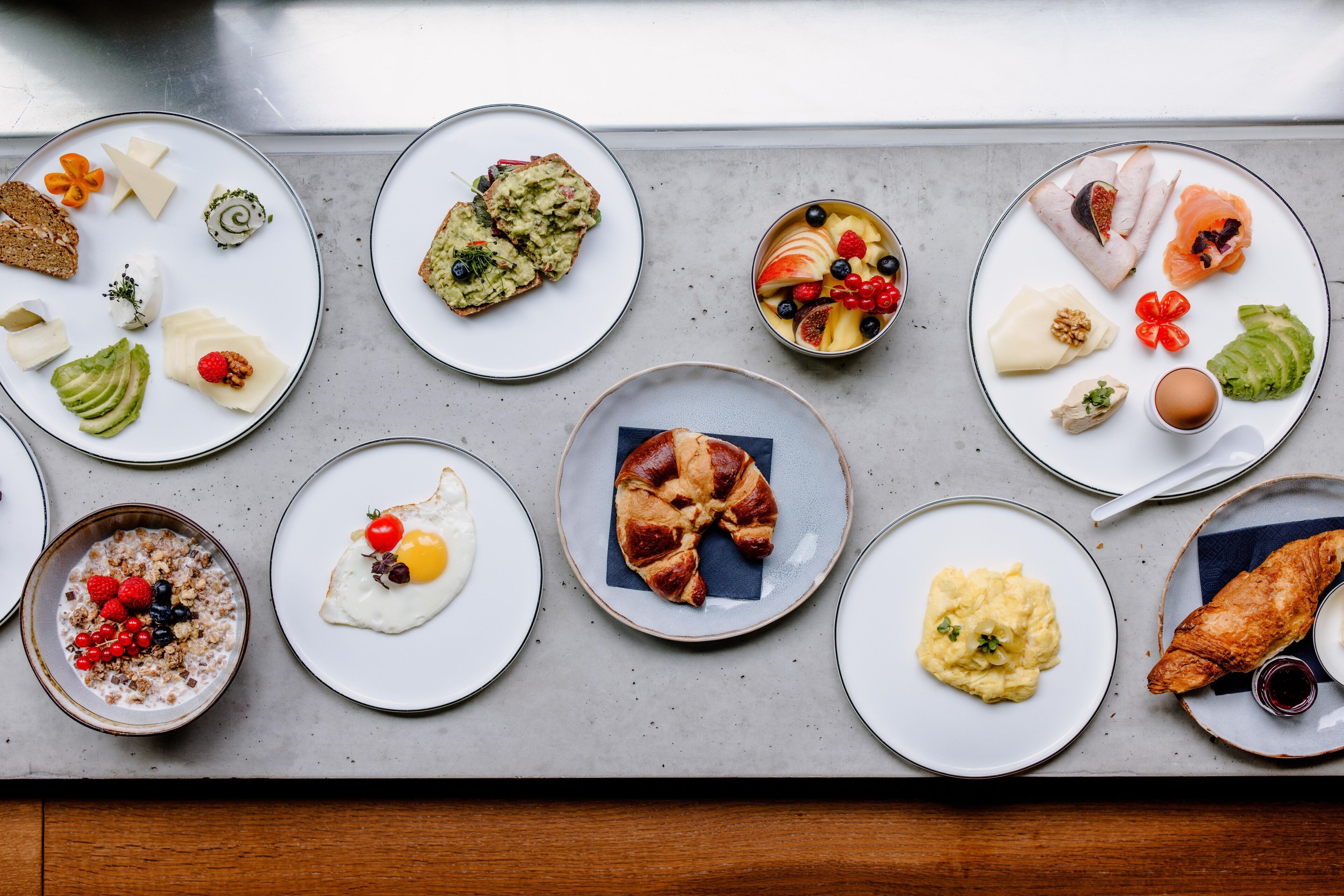A variety of breakfast dishes arranged on plates.
