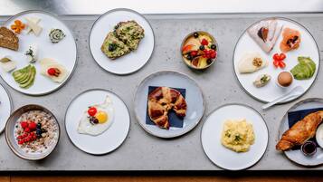 A variety of breakfast dishes arranged on plates.