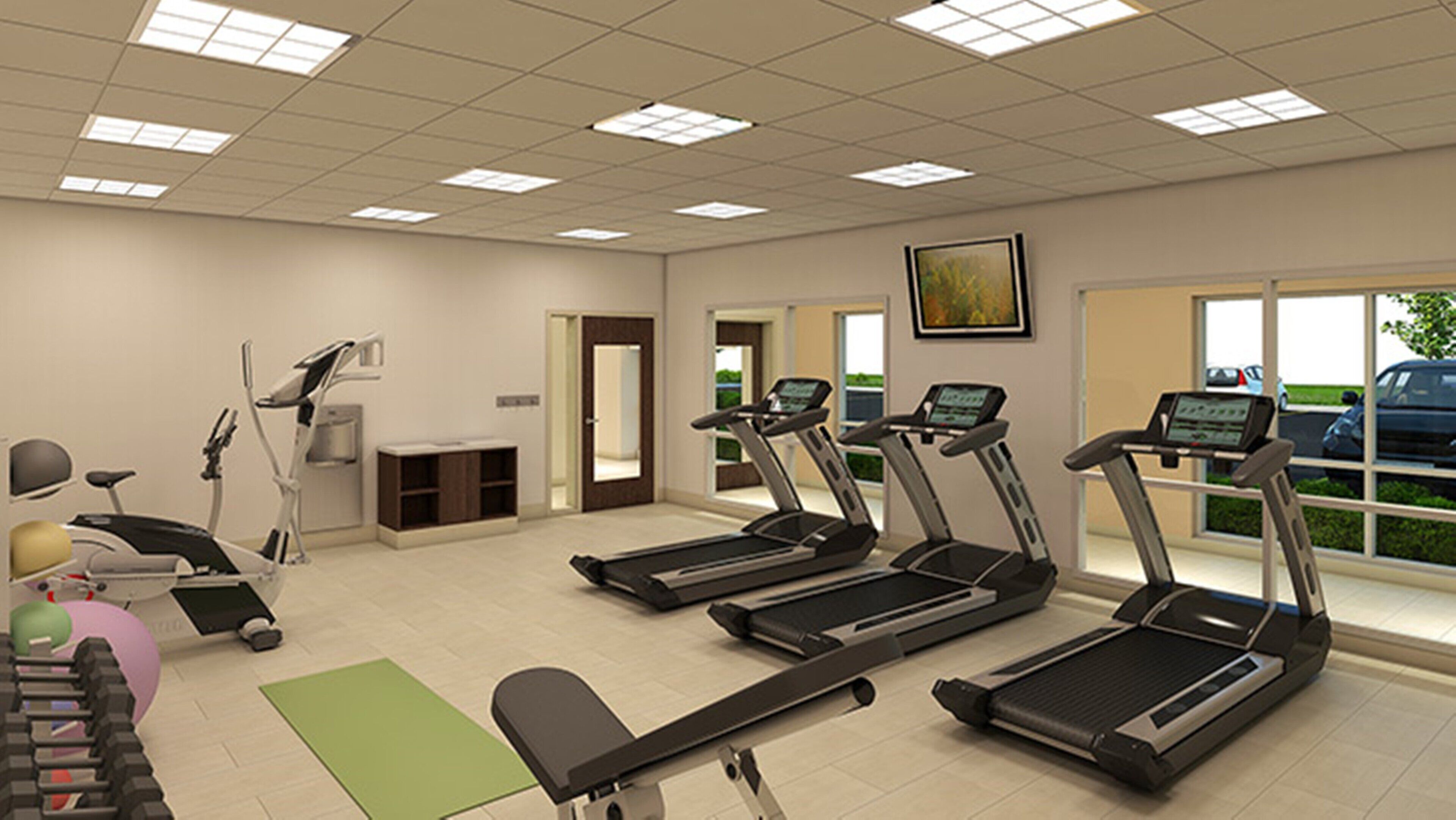 A fitness room with treadmills, a stationary bike, and a rowing machine.