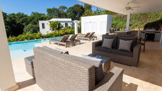 An outdoor patio with wicker furniture, a pool, and a barbecue area. - Private 3 Bedroom Villa Near Walking Trail (Sosúa)