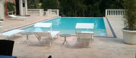 Outdoor pool, an infinity pool, sun loungers