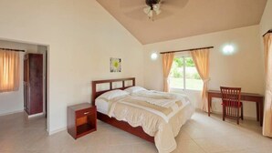 A bedroom with a bed, a desk, and a chair. - Privacy and Comfort Luxury 6 Bedroom Villa (Sosúa)