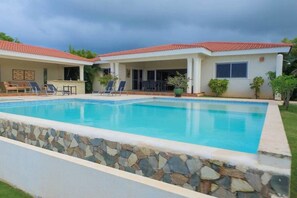Outdoor pool, an infinity pool, pool loungers