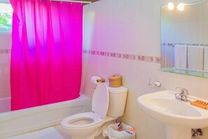 A bathroom with a white toilet, a sink, and a shower curtain. - Private Villa With Pool in Sosua for Large Groups (Sosúa)