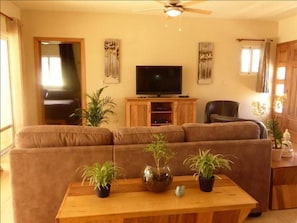 Relax in this inviting living space with a comfortable sofa, coffee table, and flat-screen TV.