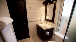 A bathroom with a sink, mirror, toilet, and towel rack. - Stylish 3 Bedroom w/ Covered BBQ Area by the Pool (Sosúa)