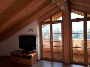 Relax in this loft-style room with a flat-screen TV, sliding glass doors, and a balcony with a view.