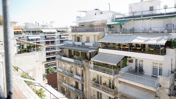 A multi-story residential building with balconies, outdoor seating areas, and a mix of architectural styles. - Downtown Penthouse Thessaloniki (Thessaloniki)