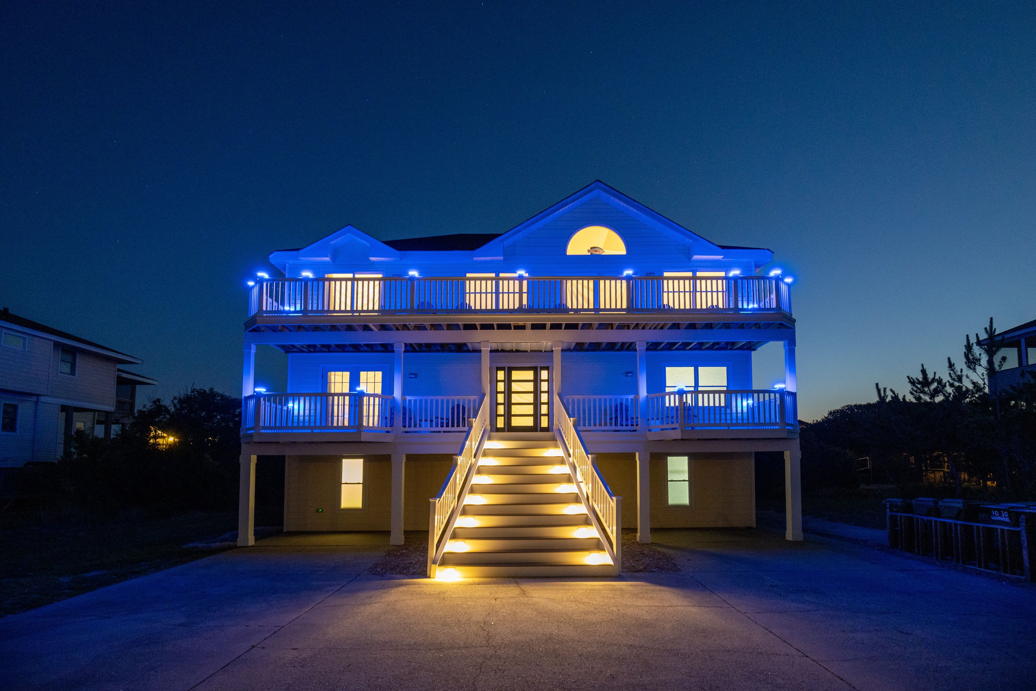 A two-story house with a central staircase and a balcony on each floor.