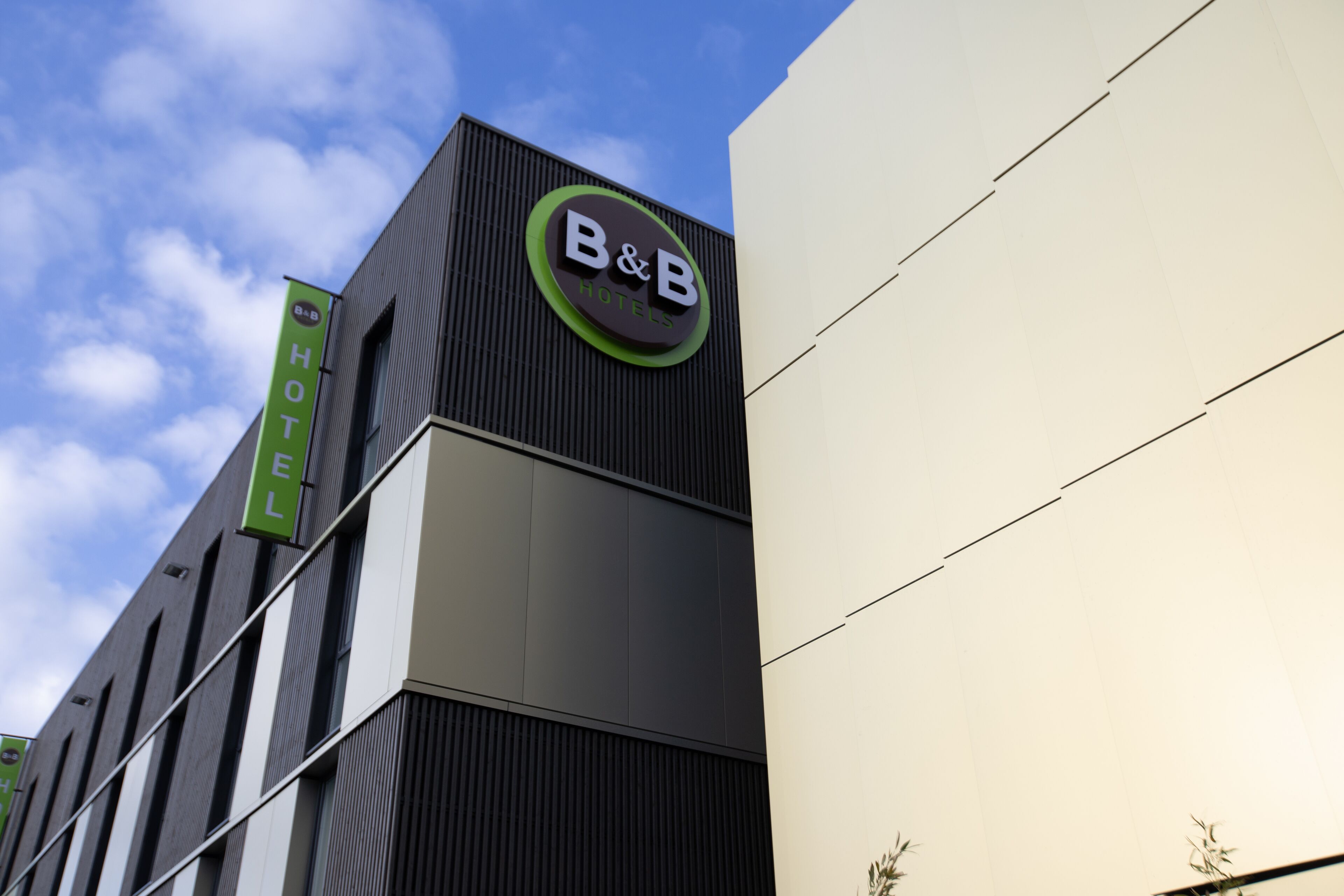 A modern building with a prominent B&B Hotels sign on the facade.