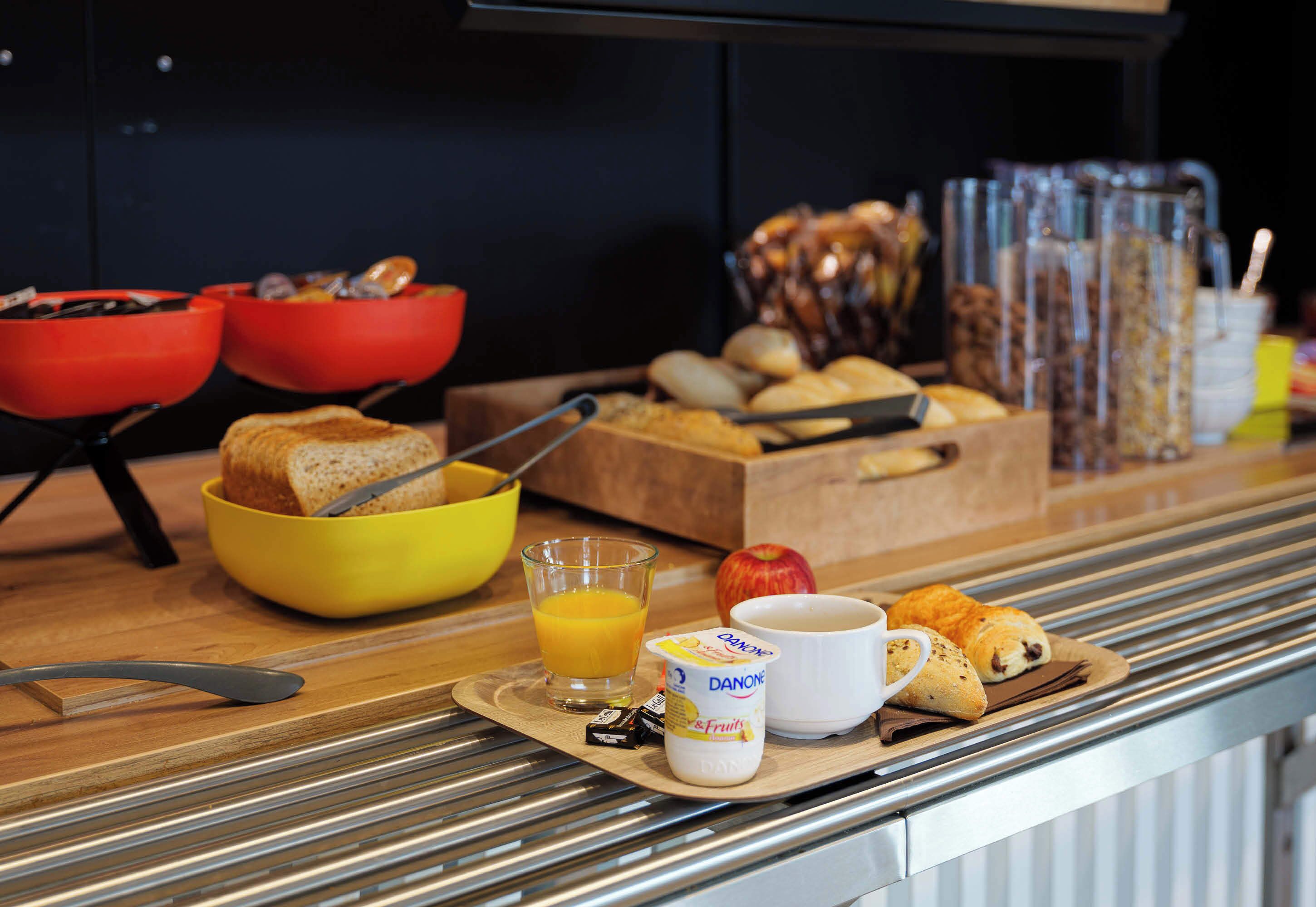 A breakfast buffet with various food items and beverages.