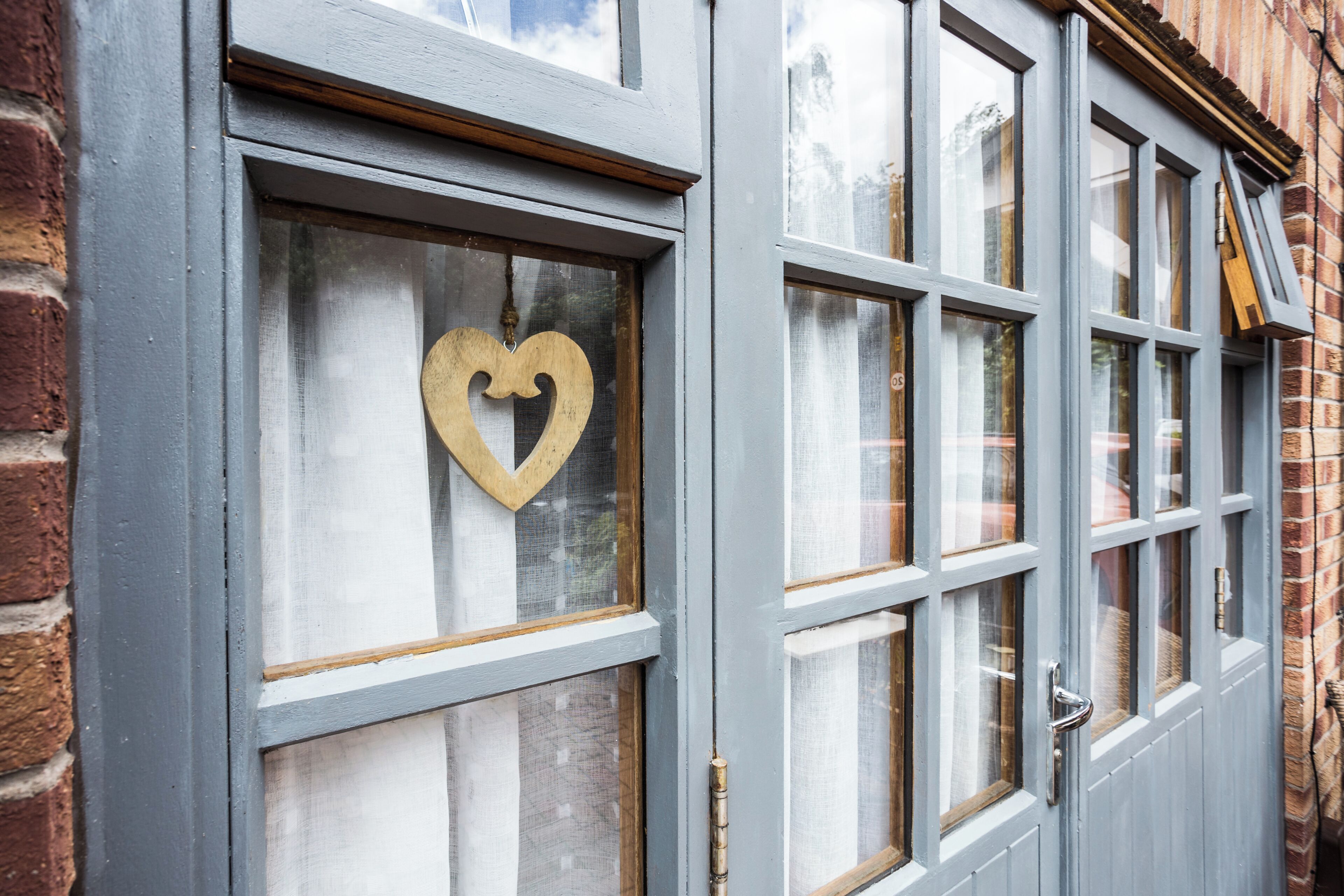 A building with a window featuring a heart-shaped decoration.