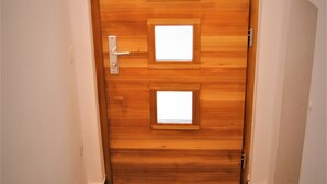 A wooden door with three rectangular windows and a door handle. - Rose Valley Ljubljana (Ljubljana)